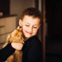Pretty Child Hugs Little Dog